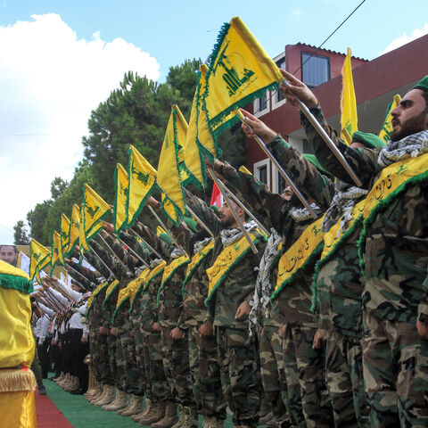 Members of the Lebanese Shiite Movement Hezbollah salute during the funeral of a comrade who was killed the previous day by the explosion of a communication device, in Adloun south of Tyre in southern Lebanon on September 19, 2024.