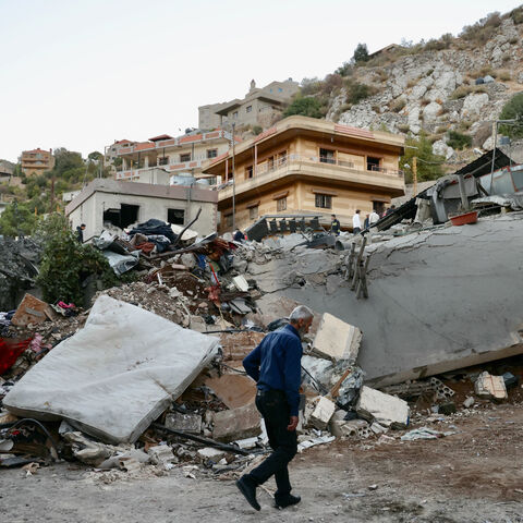 A man checks the destruction following an overnight Israeli airstrike in the southern Lebanese village of Shebaa near along the border between the two countries, on Sept. 27, 2024.