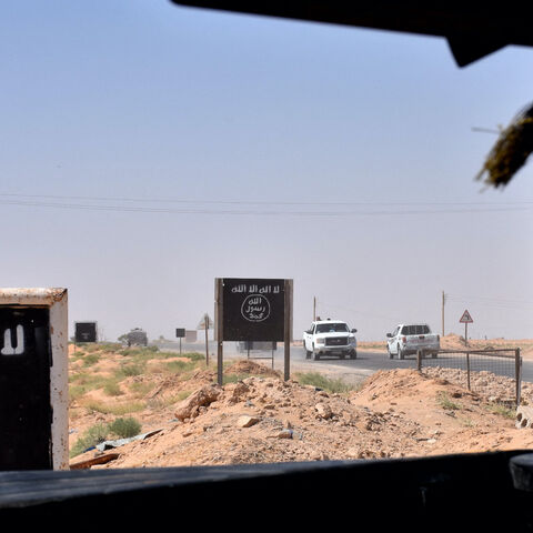 Billboards show the logo of the Islamic State (IS) group near the village of al-Maleha, in the northern countryside of Deir Ezzor, where Syrian pro-government forces are holding a position on Sept. 9, 2017, during the ongoing battle against IS jihadists. 