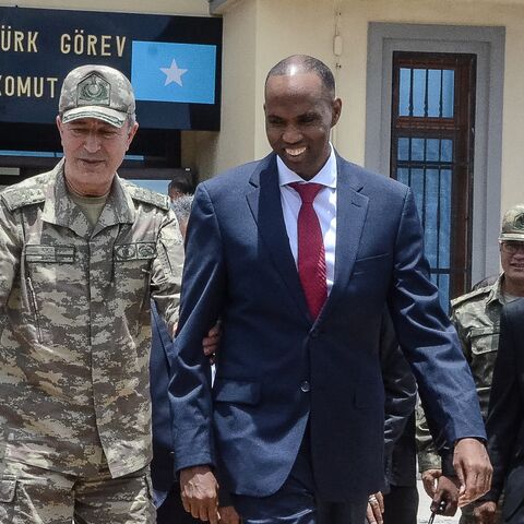 Turkish Army Chief of General Staff Hulusi Akar (L) escorts Somalia Prime Minister Hassan Ali Kheire during an inauguration ceremony of the Turkish military base in Mogadishu on Sept. 30, 2017. 