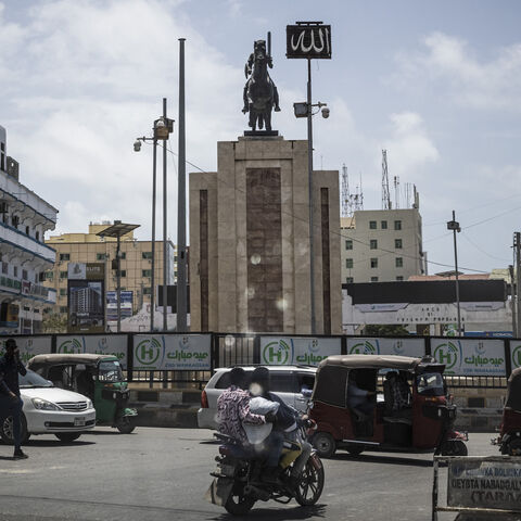 Auto rickshaws (Tuk-Tuks) and a monument are seen through the window of an armoured car on Sept. 4, 2022 in Mogadishu, Somalia. 