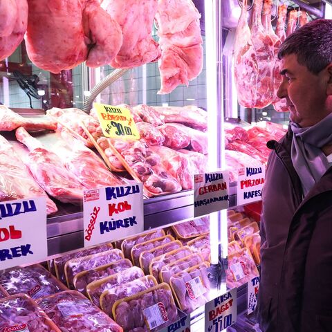 A man looks at high meat prices at a butcher in the historic Ulus district in Ankara on Jan. 27, 2023. 