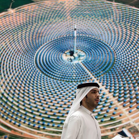 An Emirati man walks in front of the stand of Masdar City at the World Future Energy Summit exhibition in Abu Dhabi on Jan. 18, 2012.