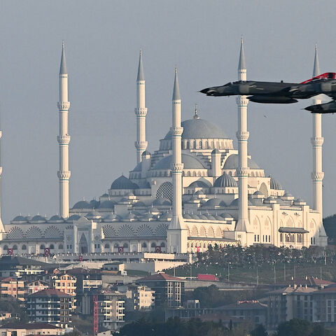 Turkish air force fighter jets perform a military parade over the Bosphorus as Camlica mosque is seen in the background to mark the 100th anniversary of Turkish Republic in Istanbul on Oct. 29,2023.  