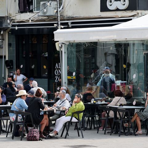 Israelis sit in a coffee shop in the Israeli coastal city of Netanya, on April 14, 2024, one day after Iran launched its first-ever direct attack on Israeli territory.