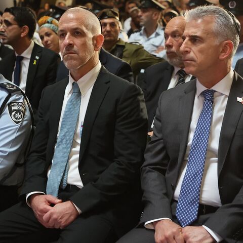 Mossad intelligence agency chief David Barnea (R) and Ronen Bar (2nd L), chief of Israel's domestic Shin Bet security agency, attend a ceremony. 