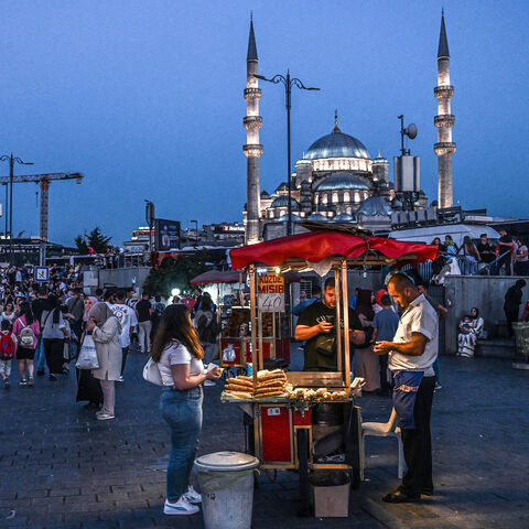 A street vendor sells corn as he waits for customers in the Eminonu district of Istanbul, Turkey, Aug. 30, 2024.