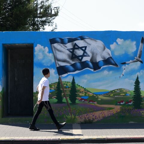 A man walks in front of the entrance of a bomb shelter in the northern Israeli town of Safed on September 29, 2024. (Photo by Menahem Kahana / AFP) (Photo by MENAHEM KAHANA/AFP via Getty Images)