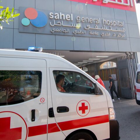 Ambulances and paramedics carry people wounded in an Israeli bombing of Beirut to Sahel Hospital.