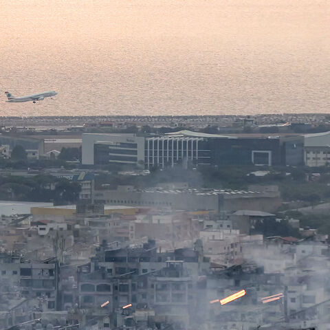 An aircraft of Middle East Airlines (MEA), Lebanon's flag carrier, takes off from Beirut International Airport on Oct. 6, 2024 amidst smoke rising from nearby sites targeted overnight by Israeli air strikes in the southern suburbs of the Lebanese capital. 