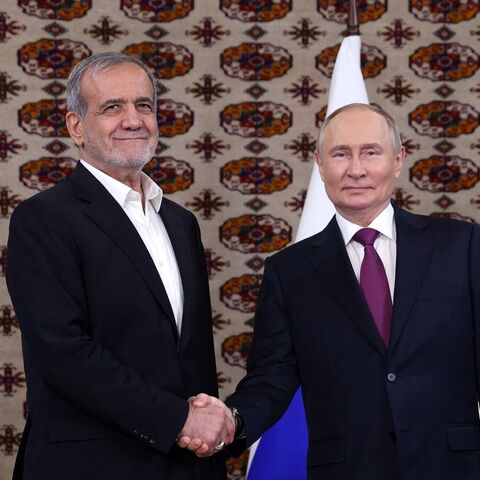 Pool photograph distributed by the Russian state agency Sputnik of Russian President Vladimir Putin meeting with Iranian President Masoud Pezeshkian in Ashgabat, Turkmenistan, Oct. 11, 2024.