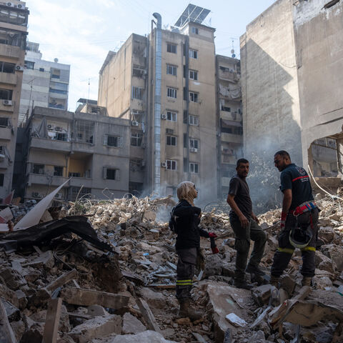 BEIRUT, LEBANON - OCTOBER 11: Emergency workers stand on rubble at the site of an Israeli airstrike on October 11, 2024 in Beirut, Lebanon. At least 22 people died, and over 100 were injured, in the strike in central Beirut last night, according to Lebanese officials. Israel said the target was a high-ranking Hezbollah official. (Photo by Carl Court/Getty Images)