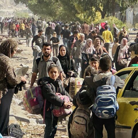 Displaced families fleeing Israeli army operations in Jabalia in northern Gaza take the main Salah al-Din road toward Gaza City on Oct. 23, 2024.