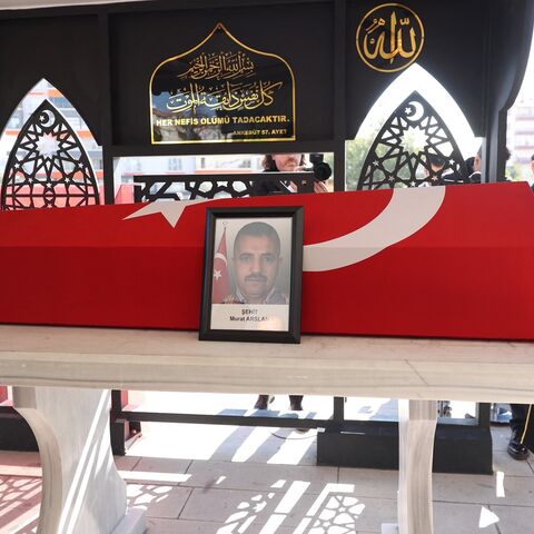 Military honour guards stand next to the coffin of taxi driver Murat Arslan, the day after he was killed in an attack at a state-run aerospace industries building in Ankara, October 24, 2024.