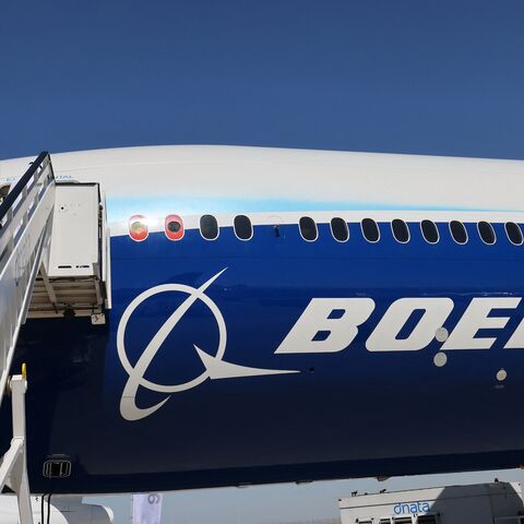 A man climbs the ramp to enter the Boeing 777X demonstration aircraft at the 2021 Dubai Airshow in the Gulf emirate, on Nov. 14, 2021.