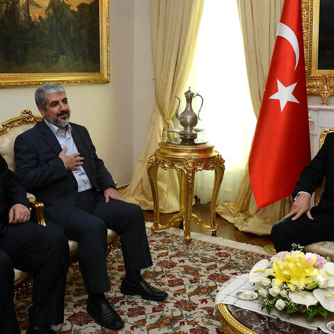 Turkish Prime Minister Recep Tayyip Erdogan (R) poses beside Khalid Mashaal (C), the Hamas chief in exile, and Gaza's prime minister Ismail Haniyeh prior to their meeting in Ankara on June 18, 2013. Senior leaders of the Palestinian Islamist movement Hamas met today in Ankara with Turkish Prime Minister Erdogan to discuss Erdogan's planned visit to the Gaza Strip as well as the situation in Syria, the source said on condition of anonymity. AFP PHOTO/ PRIME MINISTER PRESS OFFICE/ YASIN BULBUL == RESTRICTED T