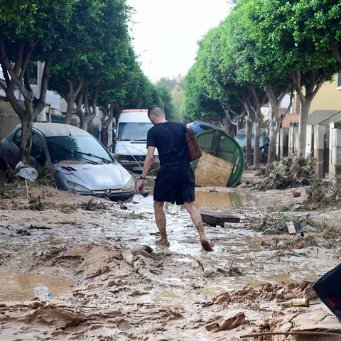 A man walks in a street covered in mud in a flooded area in Picanya, near Valencia, eastern Spain, on Oct. 30, 2024.