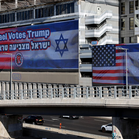 Large billboards bearing the flags of the US and Israel with a message in support of US presidential candidate Donald Trump, hang against buildings in Tel Aviv on October 30, 2024. An opinion poll conducted in September by Mitvim, the Israel Institute for Regional Foreign Policies, said 68 percent of Israelis see Trump as the candidate who will best serve Israel's interests. (Photo by JACK GUEZ / AFP) (Photo by JACK GUEZ/AFP via Getty Images)