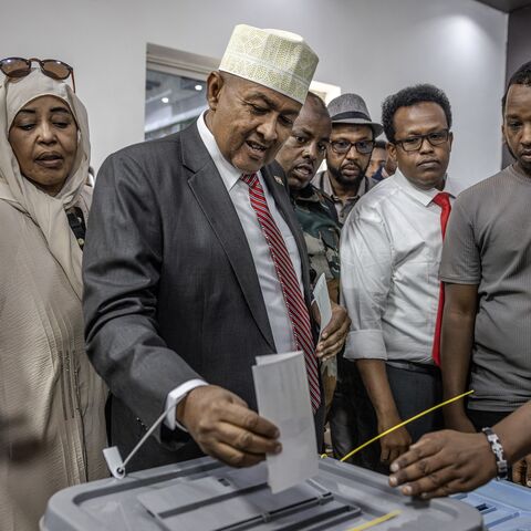 Waddani Party presidential candidate Abdirahman Mohamed Abdullahi, also known as Irro, (C) casts his vote at a polling station.