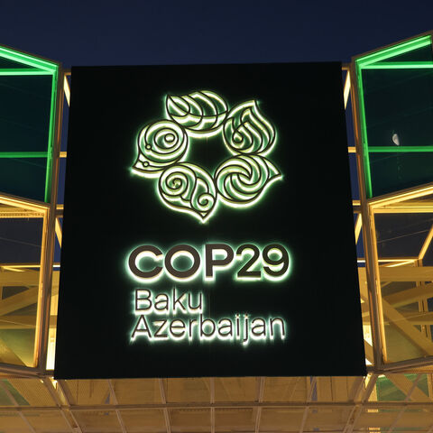 The entrance gate stands illuminated outside the conference venue prior to the COP29 Climate Conference, Baku, Azerbaijan, Nov. 10, 2024.