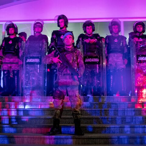 Turkish Jandarma soldiers guard the entrance to the Silivri Courthouse while awaiting the court's decision during the ongoing trial of journalists from the Cumhuriyet newspaper.