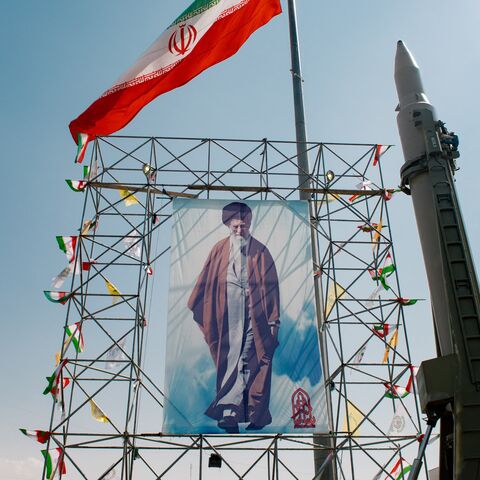 A banner depicting Iran's supreme leader, Ayatollah Ali Khamenei, stands next to a ballistic missile in Baharestan Square, Tehran, Sept. 26, 2024.