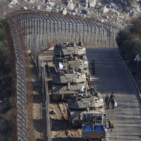 Israeli tanks take position near the fence with the buffer zone that separates the Israeli-annexed Golan Heights from the rest of Syria, near the Druze village of Majdal Shams, Dec. 8, 2024.