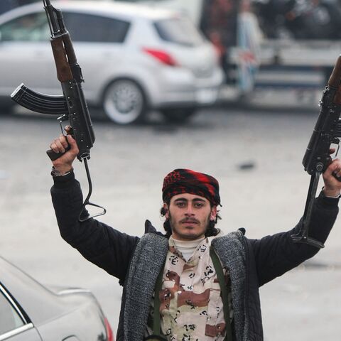 An anti-government fighter celebrates at Umayyad Square in Damascus, on Dec. 8, 2024. 