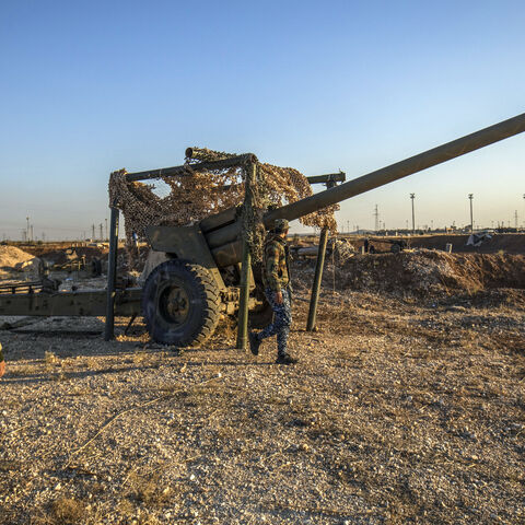 Fighters with the Kurdish-led Syrian Democratic Forces (SDF) inspect damaged and abandoned military vehicles and equipment at the Qamishli international airport, formerly a joint Syrian-russian military base, in northeastern Syria's city of Qamishli on Dec. 9, 2024. 