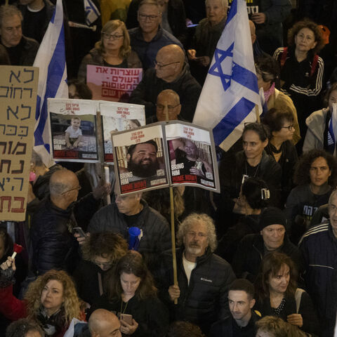 Families of hostages and supporters hold signs during a rally calling for the Israeli government to seal a hostages deal with Hamas on Dec. 14, 2024 in Tel Aviv, Israel. 