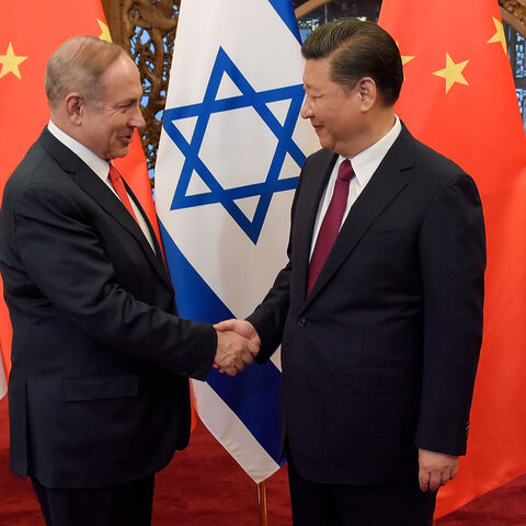 China's President Xi Jinping (R) and Israel's Prime Minister Benjamin Netanyahu shake hands ahead of their talks at Diaoyutai State Guesthouse in Beijing on March 21, 2017. / AFP PHOTO / POOL / Etienne Oliveau (Photo credit should read ETIENNE OLIVEAU/AFP via Getty Images)