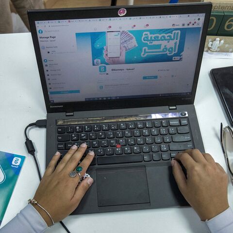 An employee at tech startup al-Gameya, uses a computer with the official Facebook page of the application open on a web browser, at the company offices in Cairo, on Sept. 12, 2021.