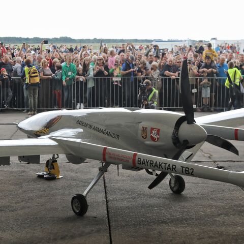 A Turkish Bayraktar TB2 combat drone is on view during a presentation at the Lithuanian Air Force Base in Siauliai, Lithuania, on July 6, 2022. - Lithuania on July 6, 2022 exhibited a crowdfunded Turkish-made military drone that it plans to send to Ukraine to help the war-torn country fight Russia's invasion. People in the NATO member country raised 5.9 million euros for the Bayraktar TB2 drone over three days last month, before its Turkish manufacturer Baykar announced it would donate the drone free of cha