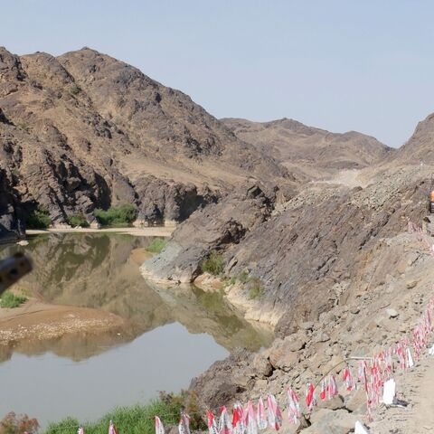 A Taliban security personnel walks along the roadside during the inauguration ceremony of Bakhshabad Dam in Bala Buluk district of Farah province on May 20, 2023. 