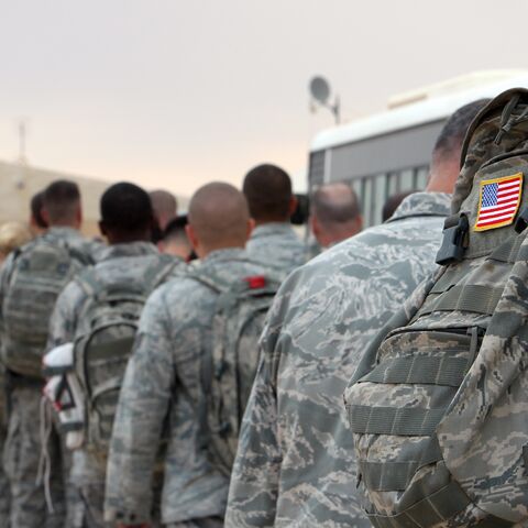 US army soldiers queue to board a plane to begin their journey home out of Iraq from the Ain al-Asad Air Base west of the capital, Baghdad, on Nov. 1, 2011.