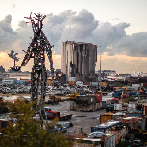 The destroyed grain silos and a sculpture made from salvaged steel following the explosion stand in the port of Beirut as the sun sets on Lebanon, Jan. 11, 2024.