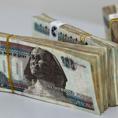 Egyptian pound banknotes sit on a table on March 6, 2024, in Cairo, after Egypt's central bank announced it will allow the exchange rate to be set by the market. 