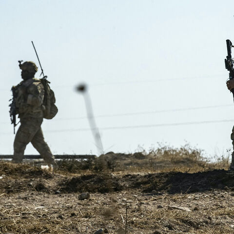 US soldiers inspect the site of reported Turkish shelling days earlier on an oil extraction facility on the outskirts of Rumaylan, in Syria's Kurdish-controlled northeastern Hasakeh province on Oct. 28, 2024. 