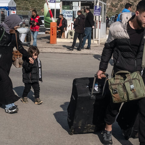 Syrians living in Turkey carry their belongings towards the Cilvegozu border gate to cross into Syria after after Syrian rebels ousted President Bashar al-Assad on Dec. 13, 2024 in Cilvegozu, Turkey. 