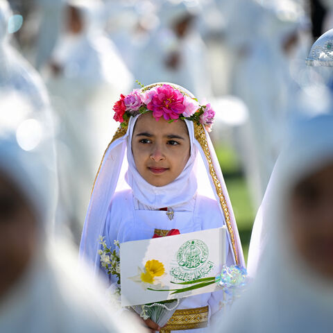 Iraqi Muslim girls, who traditionally begin wearing the hijaba head covering worn in publicat the mandatory age of nine, take part in a ceremony organized at a stadium in Basra on December 19, 2024. (Photo by Hussein FALEH / AFP) (Photo by HUSSEIN FALEH/AFP via Getty Images)