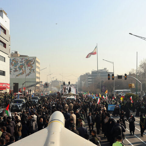 Members of Iranian paramilitary forces (Basij) march next to a Iranian long range Sejil missile, during an anti-Israeli rally to show their solidarity with the Palestinian and Lebanese people, in Tehran, Jan. 10, 2025. 