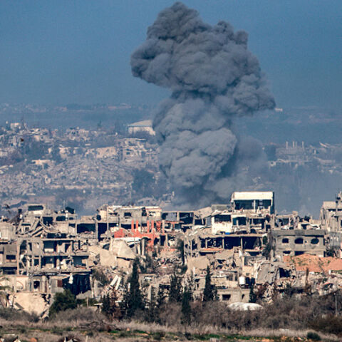 Smoke plume rising from explosions above destroyed buildings in the northern Gaza Strip on January 13, 2025 amid the ongoing war between Israel and Hamas. (Photo by Menahem KAHANA / AFP) (Photo by MENAHEM KAHANA/AFP via Getty Images)