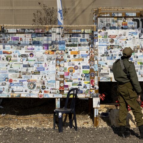 An Israeli soldier looks at a memorial wall for Israeli people and soldiers who were killed since the Oct. 7 deadly Hamas attack.