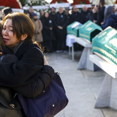Mourners react during a funeral service for Sozcu newspaper columnist and journalist Nedim Turkmen, his wife and his two children killed during a huge fire in a ski resort hotel in Bolu, at Marmara University Faculty of Theology Mosque in Istanbul on Jan. 22, 2025. 