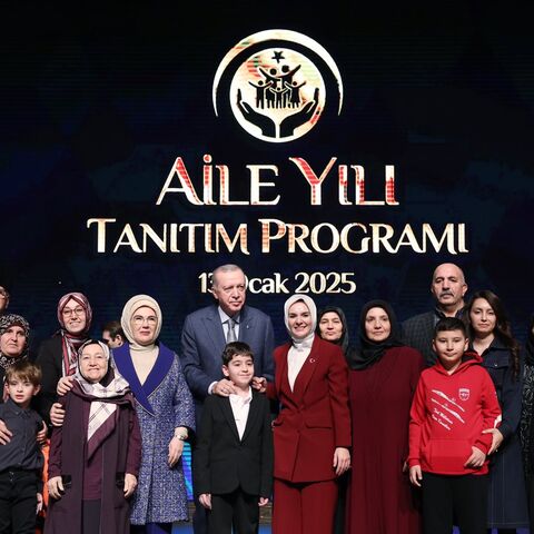 Turkish President Recep Tayyip Erdogan is joined on stage at the debut of the Year of the Family in Ankara, on Jan. 13, 2025. 