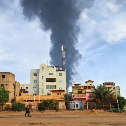 TOPSHOT - Black smoke billows behind buildings amid ongoing fighting in Khartoum on June 9, 2023. Sudan's warring generals have agreed to a 24-hour ceasefire from June 10, US and Saudi mediators said, acknowledging that previous attempts to pause a conflict now nearing its third month had proved abortive. (Photo by AFP) (Photo by -/AFP via Getty Images)