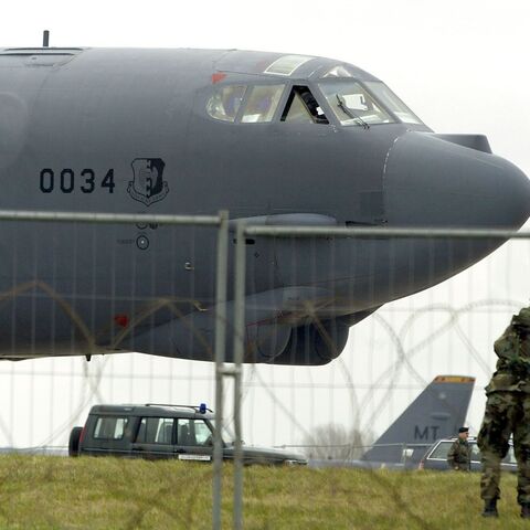 A US serviceman patrols the runway after an American B-52 bomber lands at Fairford Royal Air Force base March 4, 2003.