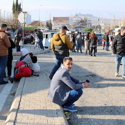 People wait at the entrance of the Al Masnaa eastern Lebanese border crossing with Syria on Jan. 3, 2025, after Syria imposed new restrictions on the entry of Lebanese citizens. 