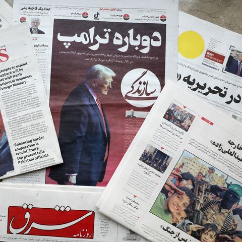 A picture shows copies of Iranian daily newspapers