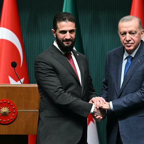 Turkish President Recep Tayyip Erdogan (R) and Syria's interim president Ahmed al-Sharaa shake hands during a joint press conference following their meeting at the Presidential Palace in Ankara, on February 4, 2025. 